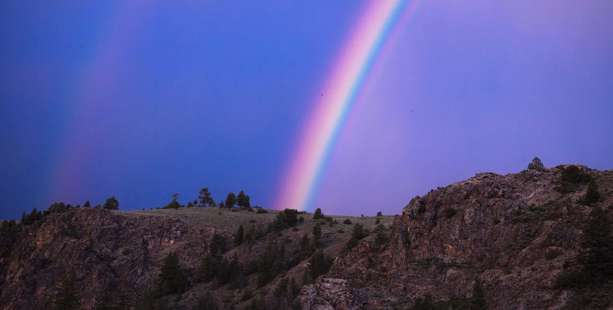 A rainbow above Taylor Canyon at sunset.
