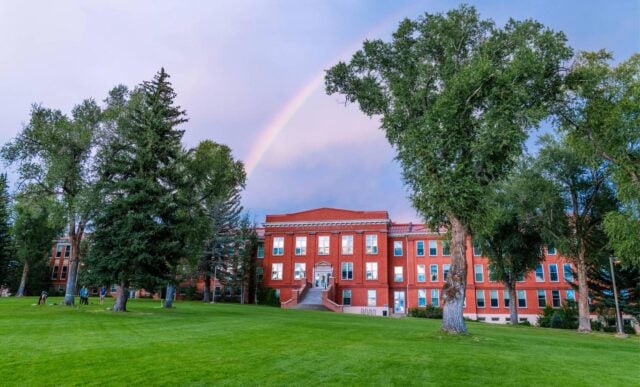 A rainbow is seen above Taylor Hall at sunset