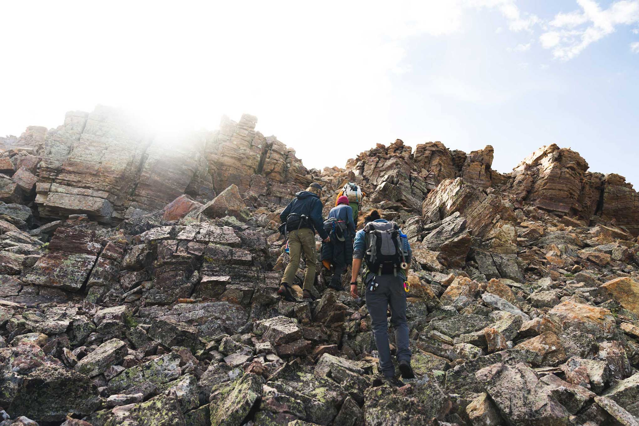 Students scramble up rocks on the mountaineering WBO trip.