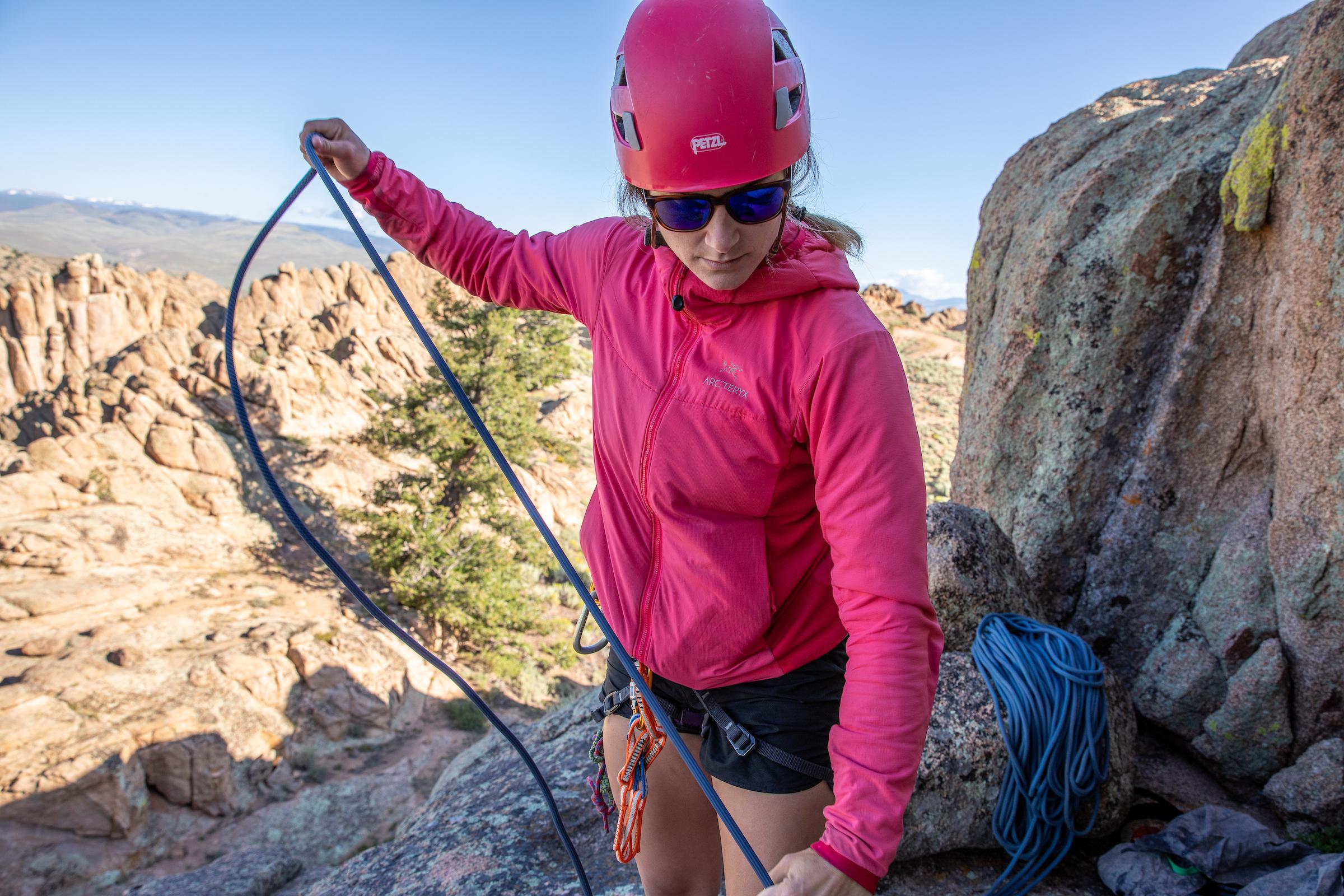 A rock climber coils rope.