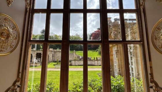 A large window overlooking a lawn at Harlaxton College.