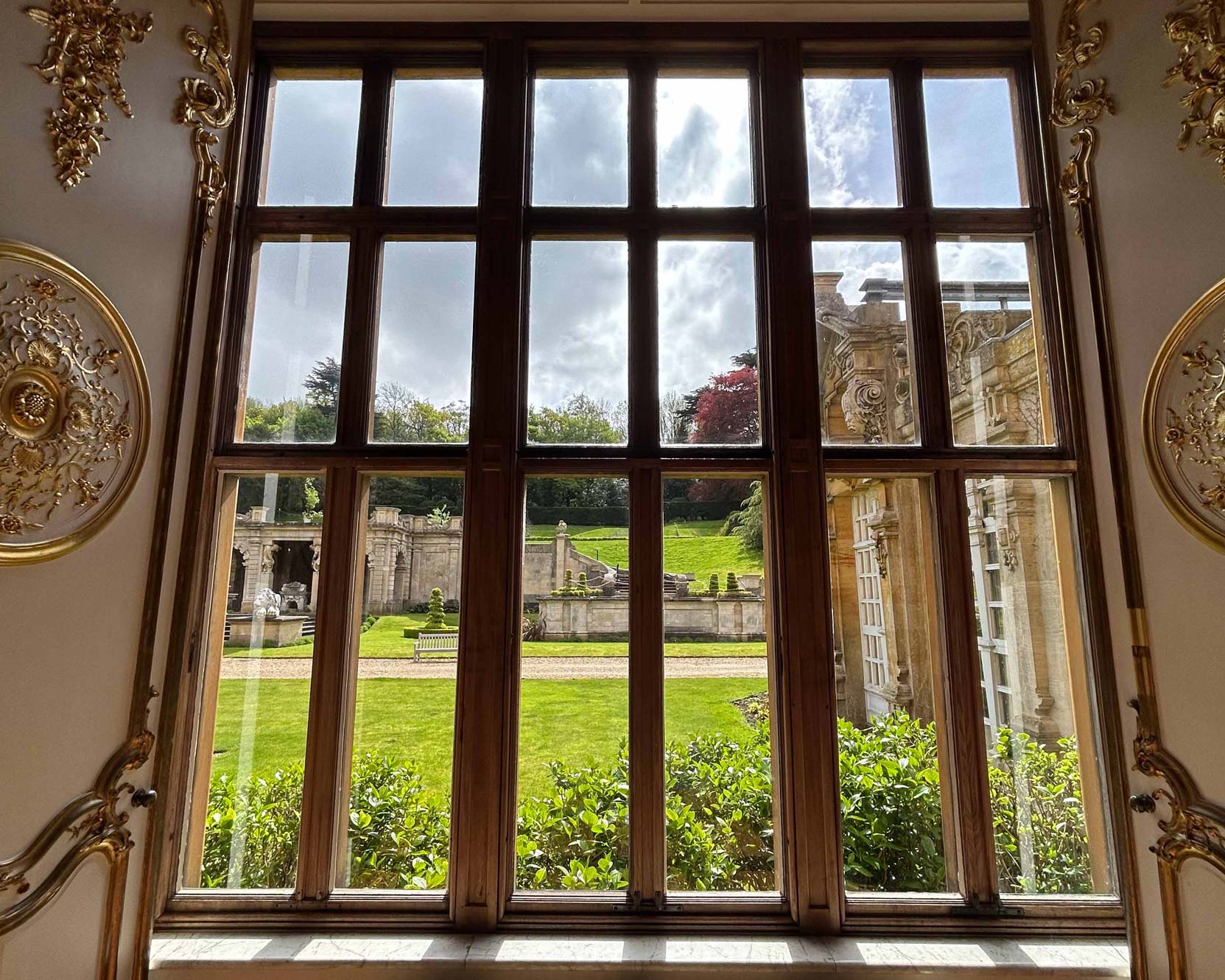 A large window overlooking a lawn at Harlaxton College.
